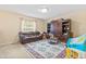 Neutral bedroom featuring a rocking horse, plush sofa, and an area rug at 10311 Frog Pond Dr, Riverview, FL 33569