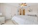 Bedroom with a neutral color scheme, ceiling fan, and large bed with an adjacent ensuite bathroom at 10311 Frog Pond Dr, Riverview, FL 33569