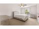 Bright bedroom featuring a upholstered bed, a ceiling fan and a window for natural light at 10311 Frog Pond Dr, Riverview, FL 33569