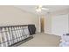 Spacious bedroom with a ceiling fan, carpeted floor, and ample closet space at 10311 Frog Pond Dr, Riverview, FL 33569