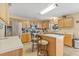Kitchen with stainless steel appliances, light wood cabinets, and breakfast bar seating at 10311 Frog Pond Dr, Riverview, FL 33569