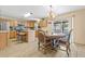 Eat-in kitchen with granite countertops, tile flooring, and a chandelier at 10311 Frog Pond Dr, Riverview, FL 33569