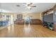 Inviting living room with hardwood floors, comfortable seating, and a large entertainment center at 10311 Frog Pond Dr, Riverview, FL 33569