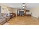 Spacious living room featuring hardwood floors, comfortable seating, and a large entertainment center at 10311 Frog Pond Dr, Riverview, FL 33569