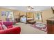 Bright main bedroom with a four-poster bed, area rug, and seating area with views of the backyard at 10311 Frog Pond Dr, Riverview, FL 33569