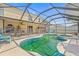 Outdoor oasis with a screened pool, spa, patio, and lush landscaping at 10311 Frog Pond Dr, Riverview, FL 33569