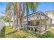 View of screened in pool with beautiful palms outside the enclosure with lounge chairs for entertaining at 10311 Frog Pond Dr, Riverview, FL 33569