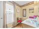Charming powder room featuring a vanity and accent chair and window with plantation shutters at 10311 Frog Pond Dr, Riverview, FL 33569