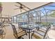 A screened in patio area overlooking a pool and a table with six chairs ready for entertaining at 10311 Frog Pond Dr, Riverview, FL 33569