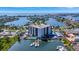 Aerial view of a waterfront condo complex with a pool, marina, and stunning city views at 10355 Paradise Blvd # 502, Treasure Island, FL 33706