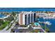Aerial view showcasing the condo's waterfront location, pool, boat access, and convenient covered parking at 10355 Paradise Blvd # 502, Treasure Island, FL 33706