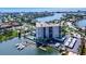 Breathtaking aerial view of waterfront condo featuring a private boat dock, community pool, and covered parking at 10355 Paradise Blvd # 502, Treasure Island, FL 33706
