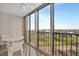 Outdoor balcony with a table and chairs offers stunning views of the surrounding area at 10355 Paradise Blvd # 502, Treasure Island, FL 33706