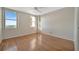Sunlit bedroom boasting hardwood floors, dual windows with a view, and ample space at 10355 Paradise Blvd # 502, Treasure Island, FL 33706