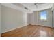 Bright bedroom with hardwood floors, a ceiling fan, a large window, and closet space at 10355 Paradise Blvd # 502, Treasure Island, FL 33706