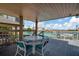 Covered outdoor deck with patio furniture overlooking the pool and waterfront at 10355 Paradise Blvd # 502, Treasure Island, FL 33706