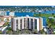 Exterior view of condo building with waterfront views, parking, and easy access to nearby attractions at 10355 Paradise Blvd # 502, Treasure Island, FL 33706