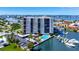 Scenic view of the condo building with a pool, boat docks and waterfront access at 10355 Paradise Blvd # 502, Treasure Island, FL 33706