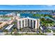 Beautiful view of the Paradise Island Towers condo building, golf course, parking area and scenic waterfront at 10355 Paradise Blvd # 502, Treasure Island, FL 33706