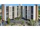 Frontal building view highlighting parking, modern architecture, and well-maintained landscaping at 10355 Paradise Blvd # 502, Treasure Island, FL 33706