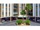 Exterior view of the building entrance, showcasing manicured landscaping and covered parking at 10355 Paradise Blvd # 502, Treasure Island, FL 33706