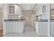 Bright kitchen with white cabinetry, tile backsplash, and modern appliances at 10355 Paradise Blvd # 502, Treasure Island, FL 33706