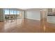 Spacious living room featuring beautiful hardwood floors and access to a balcony with outdoor seating at 10355 Paradise Blvd # 502, Treasure Island, FL 33706
