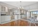 Cozy interior view showcasing the modern kitchen, hard wood floors, and natural light at 10355 Paradise Blvd # 502, Treasure Island, FL 33706