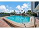 Community pool with a convenient entry ramp and ample space for lounging and relaxation at 10355 Paradise Blvd # 502, Treasure Island, FL 33706