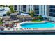 Community pool with gazebos, seating, and a well-kept deck in a beautiful waterfront setting at 10355 Paradise Blvd # 502, Treasure Island, FL 33706