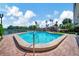 Community pool with blue water at 10355 Paradise Blvd # 502, Treasure Island, FL 33706