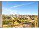 Expansive view of a neighborhood, palm trees, blue skies, and waterways from a high-rise window at 10355 Paradise Blvd # 502, Treasure Island, FL 33706