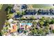 Aerial view showcases community, surrounding landscaping, canal and nearby community pool at 10733 Drummond Rd, Tampa, FL 33615