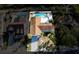 Aerial view showcasing the home, backyard pool, and surrounding landscaping at 10733 Drummond Rd, Tampa, FL 33615