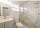 Updated bathroom featuring gold hardware, walk-in shower and modern vanity at 10733 Drummond Rd, Tampa, FL 33615
