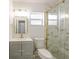 Nicely renovated bathroom with gold accents, a walk-in shower and stylish vanity at 10733 Drummond Rd, Tampa, FL 33615
