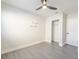 This bedroom features wood-look floors, a ceiling fan, and is brightly lit with natural light at 10733 Drummond Rd, Tampa, FL 33615