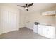 Bonus room with kitchenette, wood-look floors, closet and door leading to additional space at 10733 Drummond Rd, Tampa, FL 33615