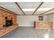 Bonus room features a brick fireplace, tile flooring, and a bar with seating at 10733 Drummond Rd, Tampa, FL 33615