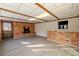 Bonus room features a brick fireplace, tile flooring, and a bar with seating at 10733 Drummond Rd, Tampa, FL 33615
