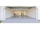 Spacious garage with washer, dryer, water heater and painted floor at 10733 Drummond Rd, Tampa, FL 33615