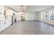 Spacious kitchen featuring stainless appliances, white cabinets, stone countertops, and gray vinyl flooring at 10733 Drummond Rd, Tampa, FL 33615
