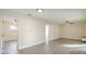 Bright living room featuring neutral paint, light-colored wood-look floors, and modern ceiling fans at 10733 Drummond Rd, Tampa, FL 33615