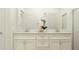 Elegant bathroom featuring double vanity with stone countertop, shaker cabinets, and modern fixtures at 10873 Rustic Eve Ct, Land O Lakes, FL 34638
