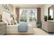 Bedroom with two windows, matching nightstands, soft rug, and comfortable furnishings at 10873 Rustic Eve Ct, Land O Lakes, FL 34638