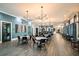Upscale clubhouse featuring dining tables, modern chandeliers, and elegant finishes at 10873 Rustic Eve Ct, Land O Lakes, FL 34638