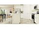 Bright kitchen with white cabinets, modern appliances, and a kitchen island with seating at 10873 Rustic Eve Ct, Land O Lakes, FL 34638