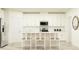 Modern kitchen featuring sleek white cabinetry, stainless steel appliances, and a center island at 10873 Rustic Eve Ct, Land O Lakes, FL 34638