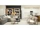 Modern living room with gray sofa, stylish decor and an open-concept to white kitchen at 10873 Rustic Eve Ct, Land O Lakes, FL 34638
