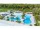 Aerial view of community pool and lounging area surrounded by palm trees at 10873 Rustic Eve Ct, Land O Lakes, FL 34638